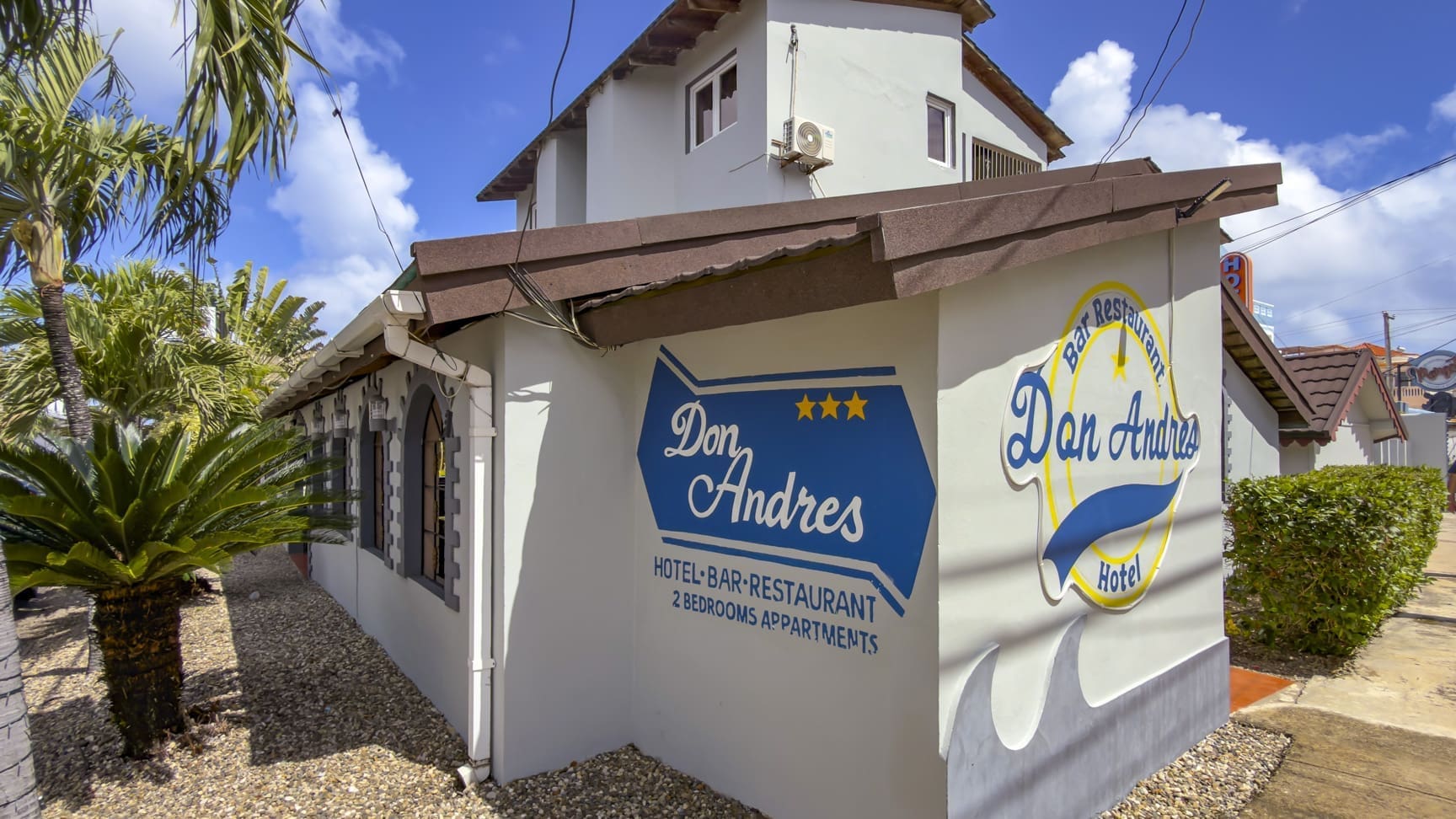 buyDRproperty Don Andres Hotel, Bar & Restaurant in Aruba: exterior view of the building with signage. Sosua Real Estate