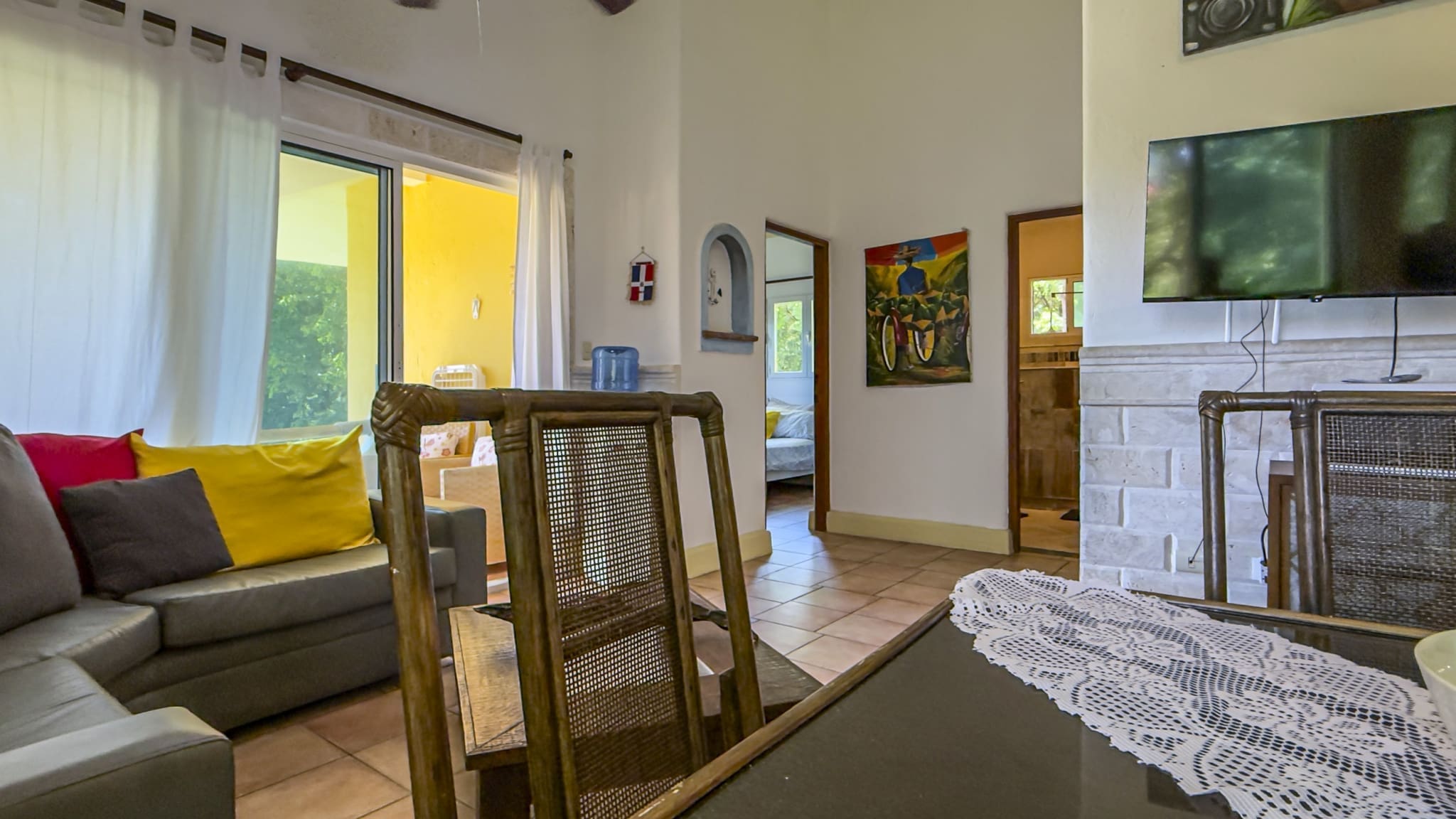 buyDRproperty Living room with sofa, dining table, and open doorway to a bedroom. Sosua Real Estate