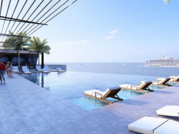 buyDRproperty Luxury infinity pool with cruise ship and lounge chairs overlooking the ocean Sosua Real Estate