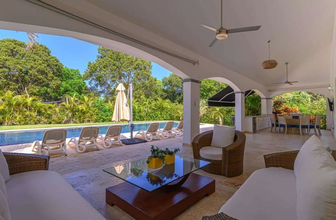 buyDRproperty Luxury villa patio with pool, lounge chairs, and outdoor dining area Sosua Real Estate