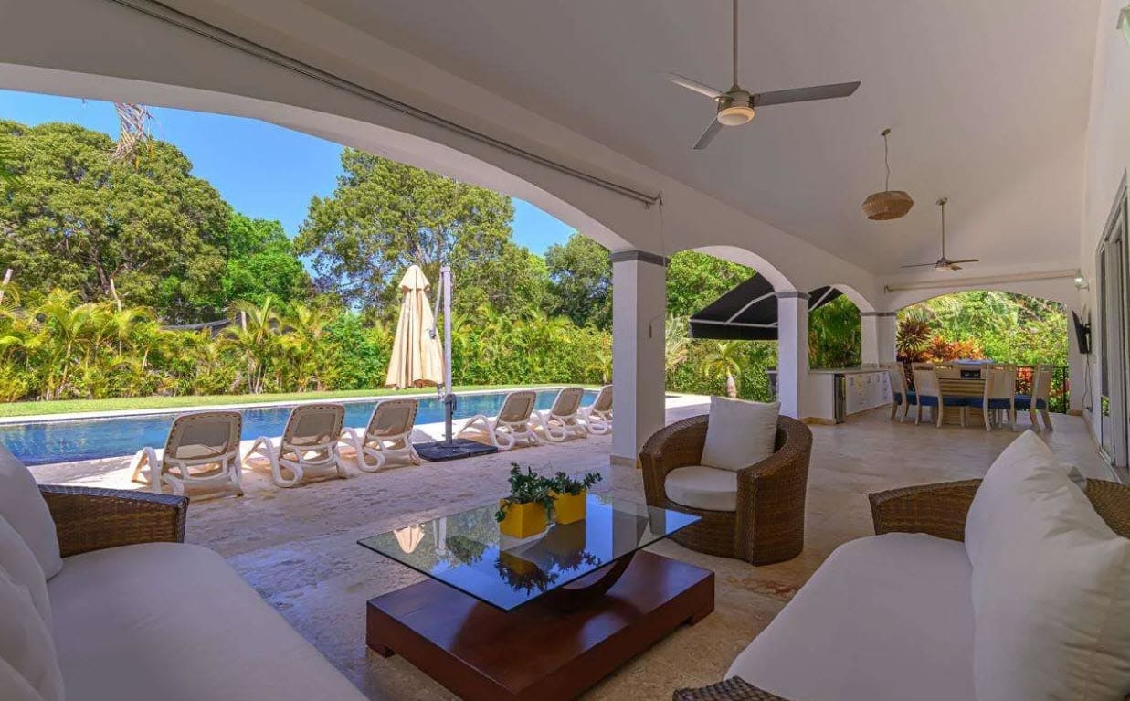 buyDRproperty Luxury villa patio with pool, lounge chairs, and outdoor dining area Sosua Real Estate