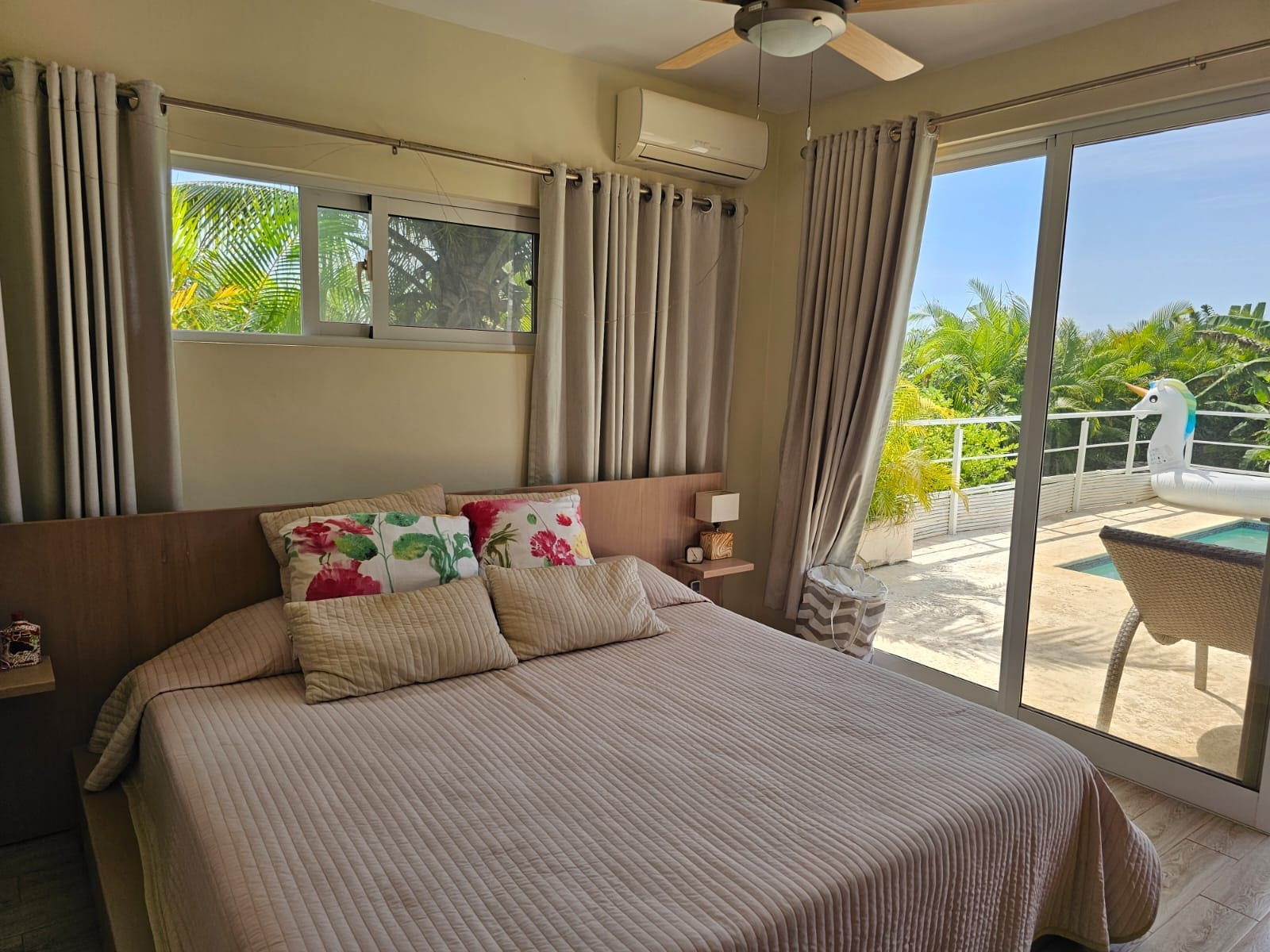 buyDRproperty Bedroom with tropical view and pool access, featuring a king-size bed. Sosua Real Estate