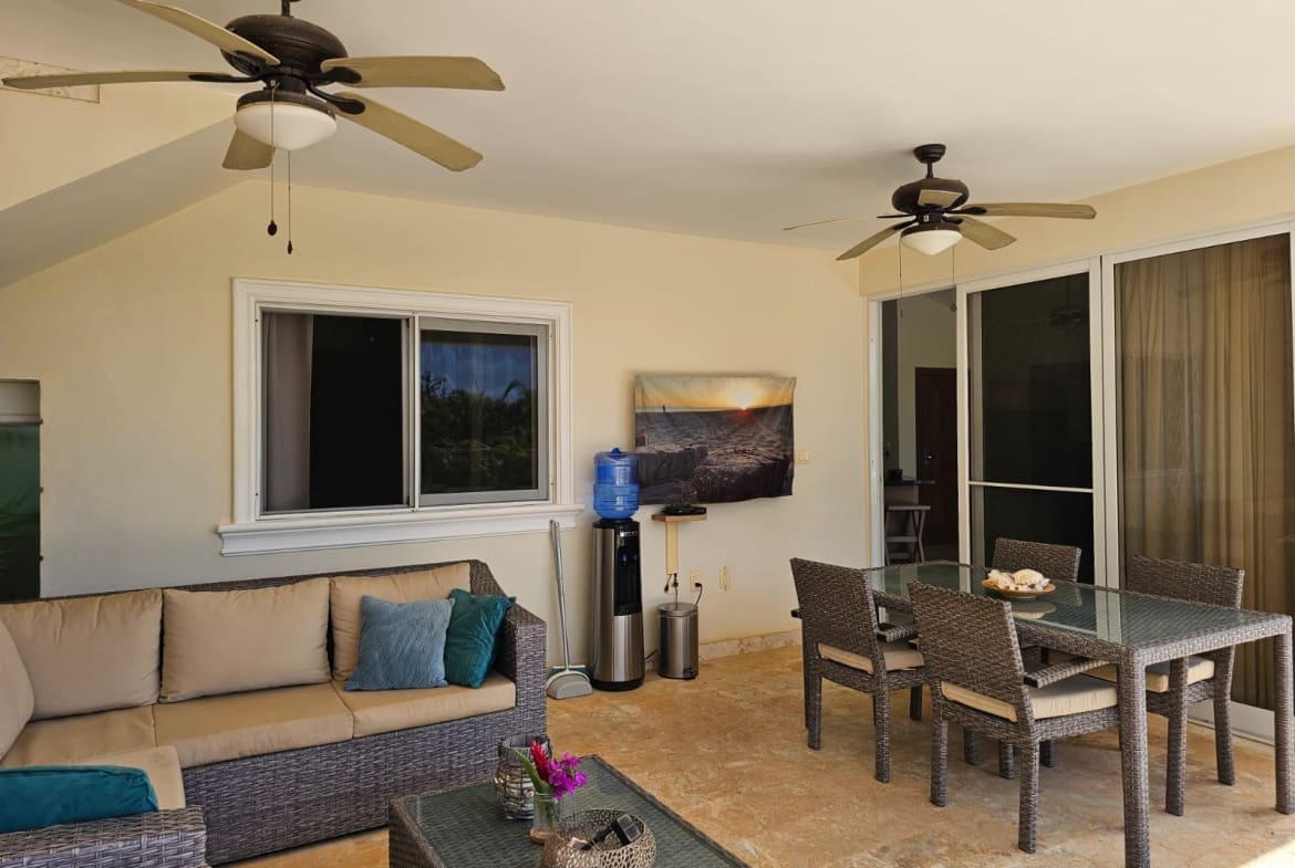 buyDRproperty Covered patio with rattan furniture, dining set, and ceiling fans Sosua Real Estate