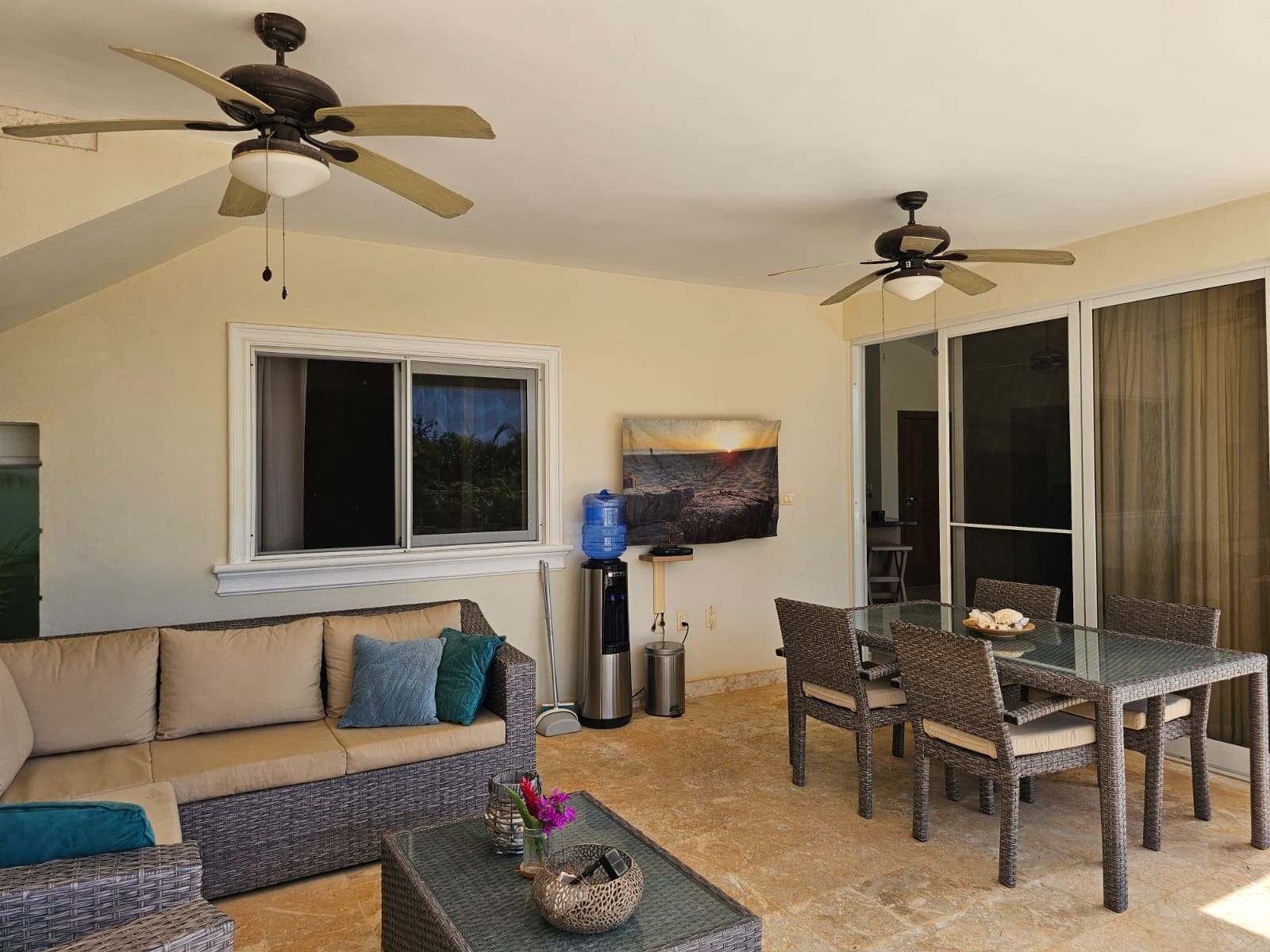 buyDRproperty Covered patio with rattan furniture, dining set, and ceiling fans Sosua Real Estate