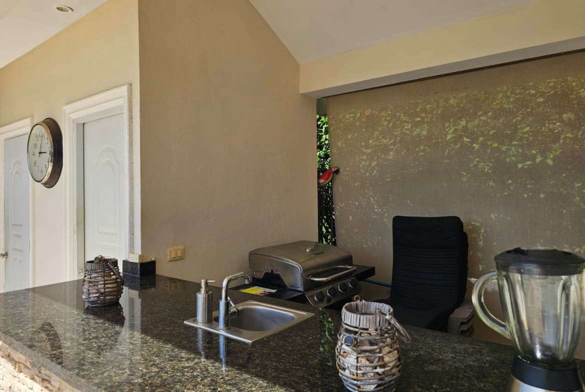 buyDRproperty Outdoor kitchen bar with grill, sink, and blender, perfect for entertaining. Sosua Real Estate