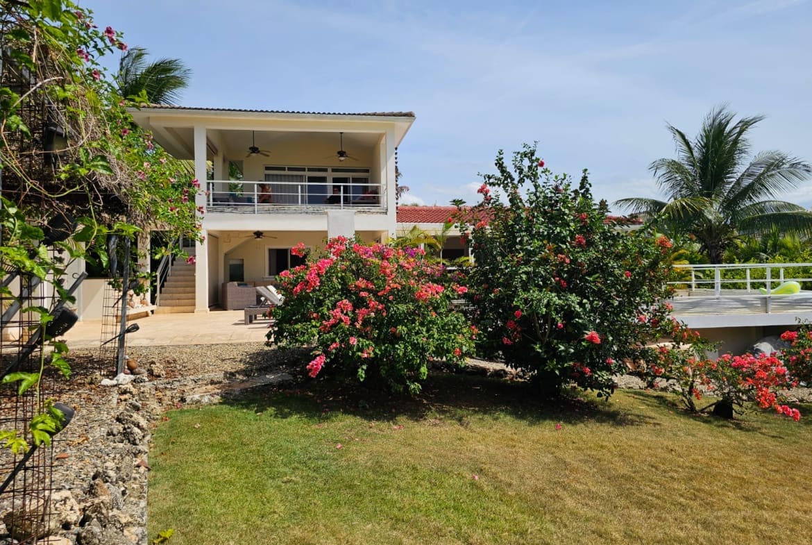 buyDRproperty Tropical villa with bougainvillea flowers and palm trees Sosua Real Estate