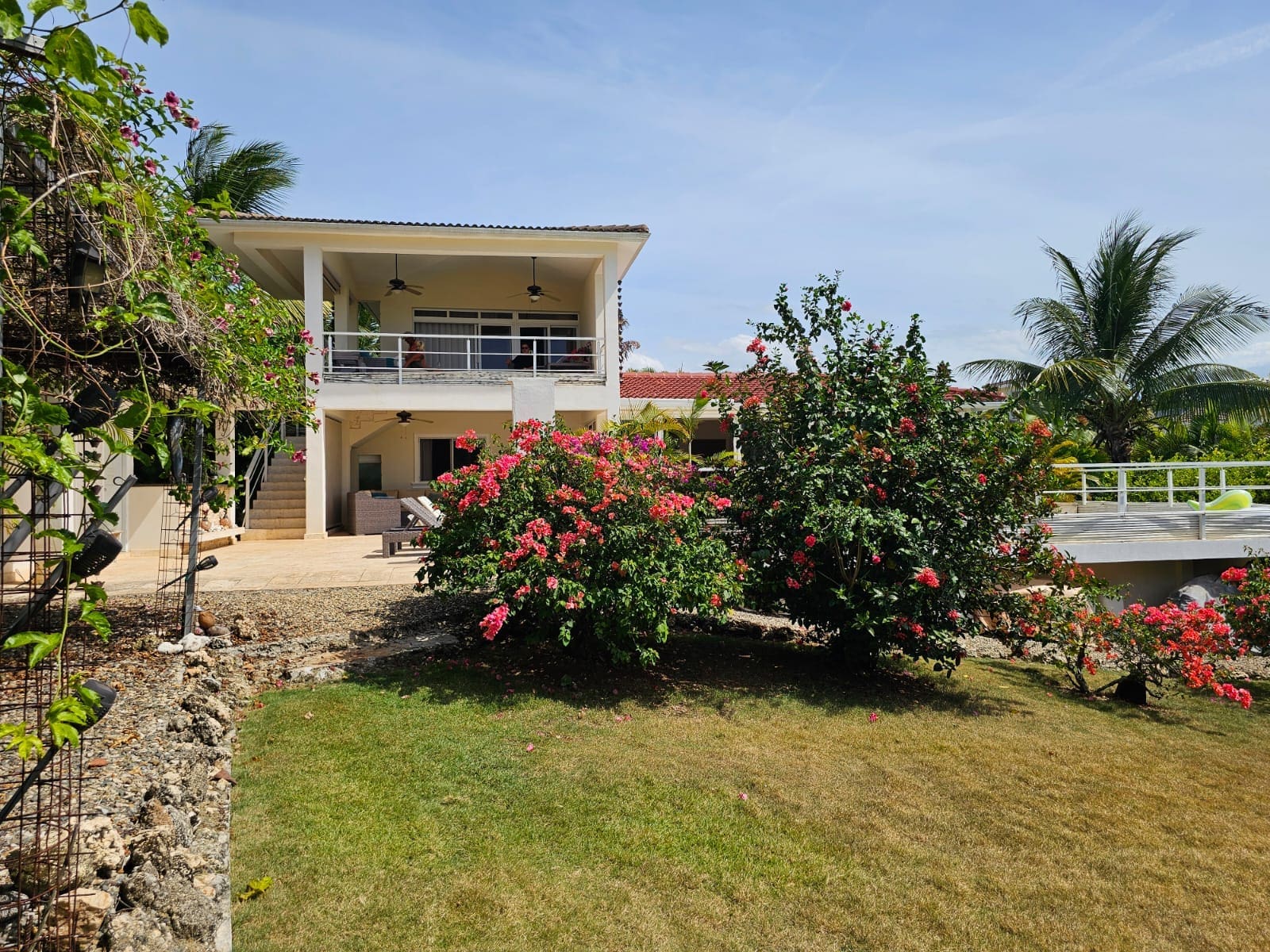 buyDRproperty Tropical villa with bougainvillea flowers and palm trees Sosua Real Estate