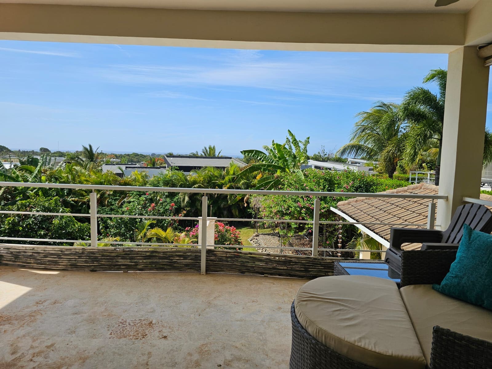 buyDRproperty Balcony view of lush tropical foliage and ocean horizon. Sosua Real Estate