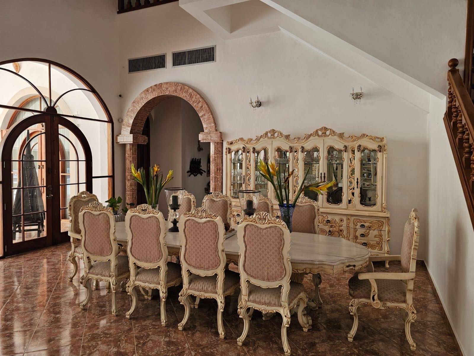 buyDRproperty Elegant dining room with a large ornate table, chairs, and a china cabinet. Sosua Real Estate