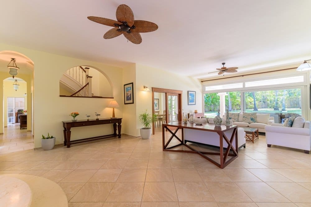 buyDRproperty Spacious, light-filled living room with modern furniture and tropical outdoor view Sosua Real Estate