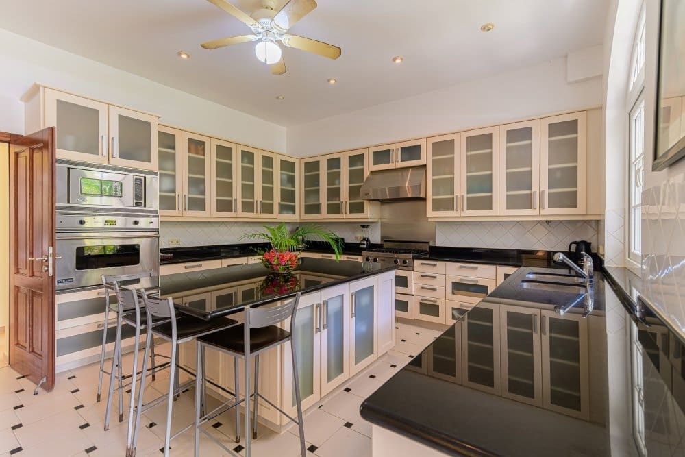 buyDRproperty Spacious modern kitchen with large island, stainless steel appliances, and ample cabinetry. Sosua Real Estate