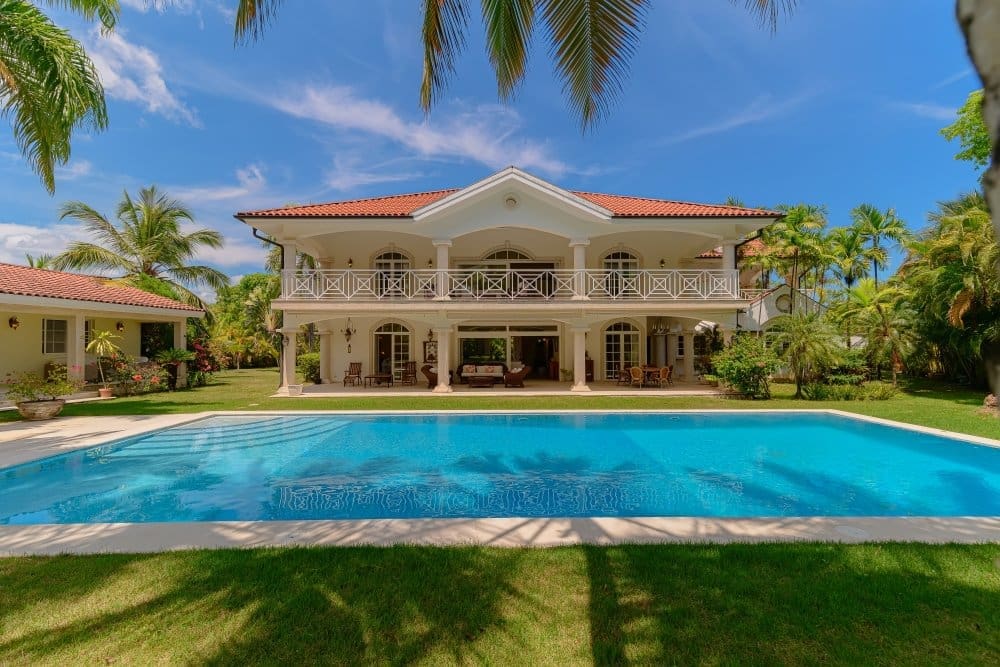 buyDRproperty Luxury villa with large pool and palm trees, tropical paradise vacation home Sosua Real Estate