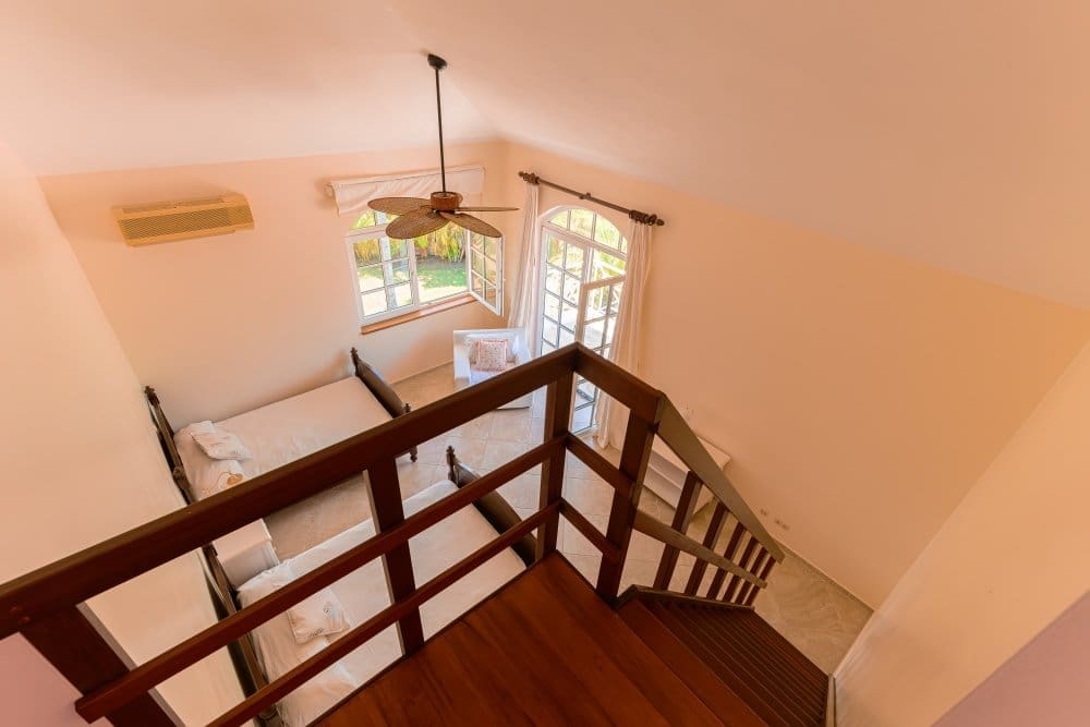 buyDRproperty View from above of a bedroom with two beds, a ceiling fan, and a window. Sosua Real Estate