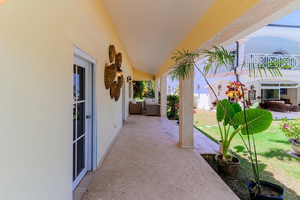 buyDRproperty Covered patio with tropical plants and a view of a white balcony. Sosua Real Estate