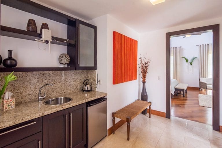 buyDRproperty Compact kitchenette with sink, mini-fridge, and coffee maker in a hotel room Sosua Real Estate