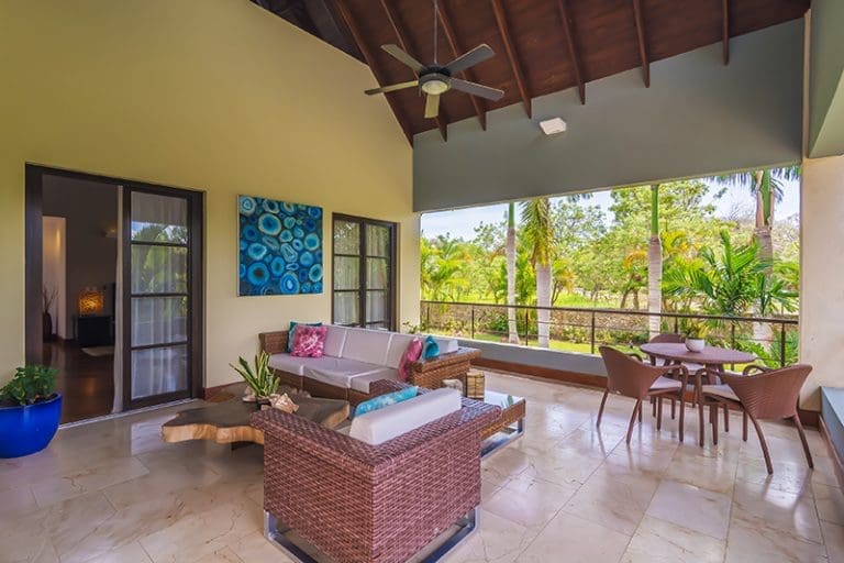 buyDRproperty Spacious covered patio with outdoor furniture and tropical views Sosua Real Estate