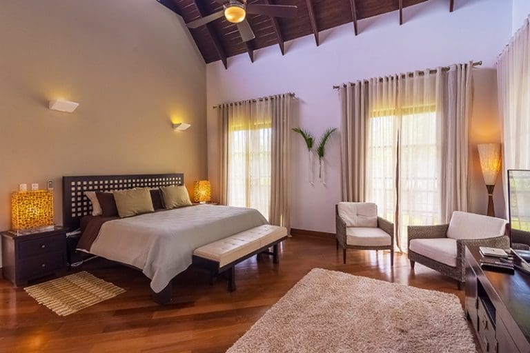 buyDRproperty Spacious bedroom with vaulted ceiling, king bed, and natural light Sosua Real Estate