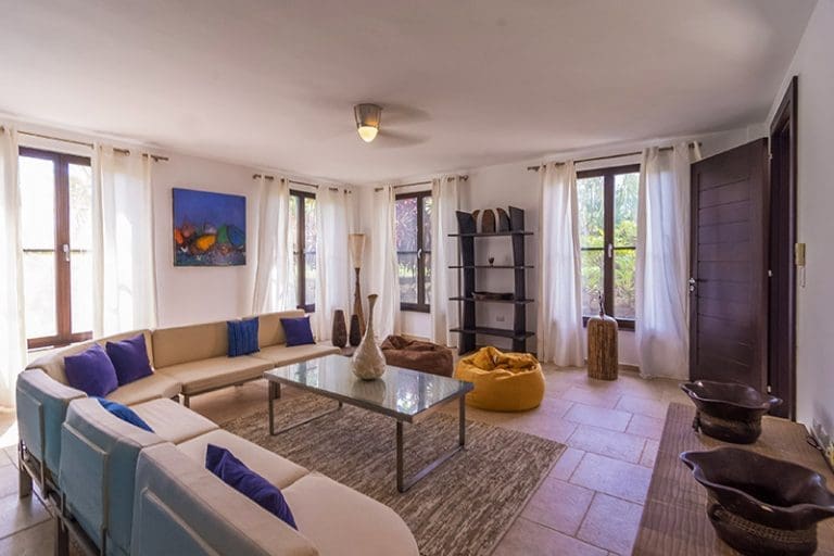 buyDRproperty Spacious living room with large sectional sofa, bean bags, and artwork Sosua Real Estate