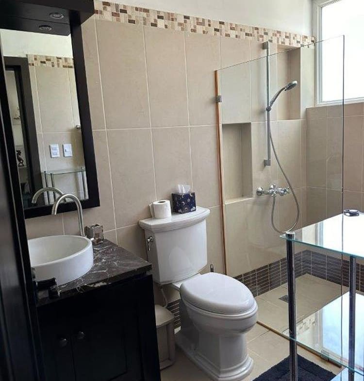 buyDRproperty Modern bathroom with a tiled shower, vessel sink, and dark vanity Sosua Real Estate