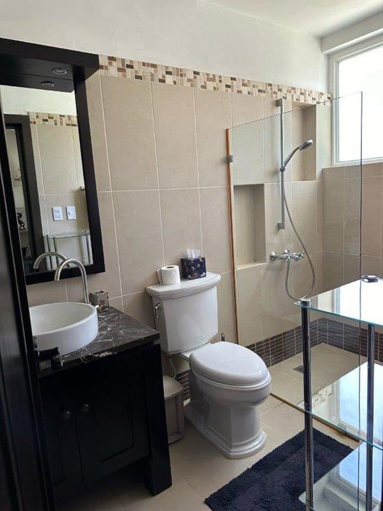 buyDRproperty Modern bathroom with a tiled shower, vessel sink, and dark vanity Sosua Real Estate