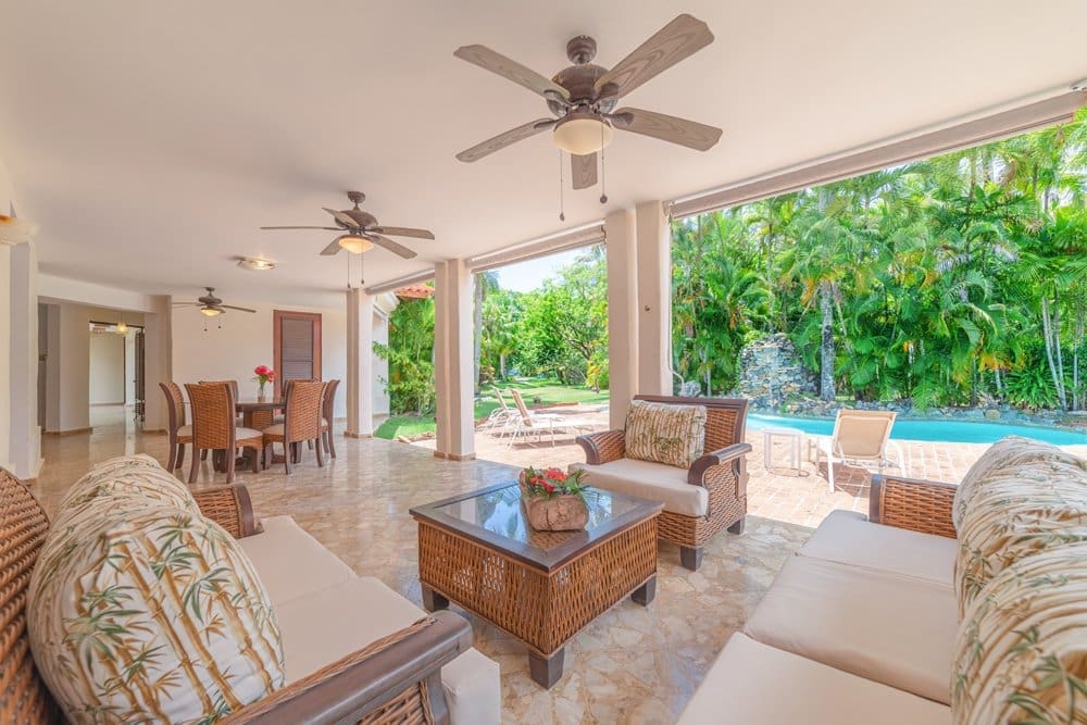 buyDRproperty Covered patio with seating and a pool view, tropical landscaping Sosua Real Estate