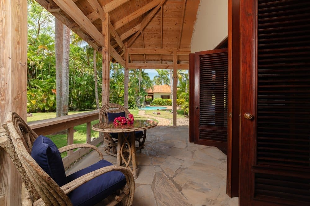 buyDRproperty Tropical porch with wicker chairs, table, and garden view Sosua Real Estate