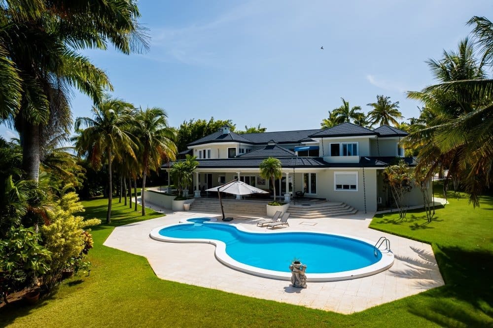 buyDRproperty Luxury villa with a freeform pool and lush tropical landscaping. Sosua Real Estate